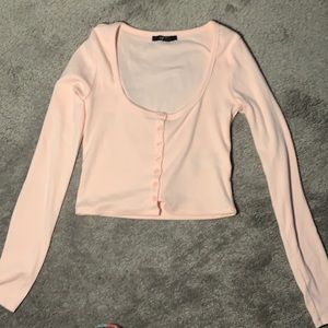 Between pink and cream color long sleeve crop top. Nice material.
